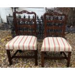 A PAIR OF 19TH CENTURY MAHOGANY PIERCED LADDER BACK STANDARD CHAIRS With overstuffed upholstered