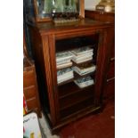 AN EDWARDIAN ROSEWOOD MUSIC CABINET The single glazed door enclosing shelves, along with a