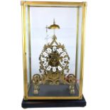 A LARGE PIERCED BRASS SKELENTON CLOCK With fusée movement in glass and brass bound display case. (