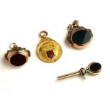 TWO EARLY 20TH CENTURY 9CT GOLD AND HARDSTONE SWIVEL WATCH FOBS Comprising a double side fob with