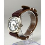 AN EARLY 20TH CENTURY SILVER WRISTWATCH Black and cream dial, on later brown leather strap. (
