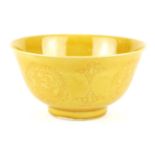 A CHINESE YELLOW GLAZE BOWL Having incised underglaze decoration of a dragon with flaming pearl,