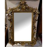 A 19TH CENTURY FLORENTINE GILTWOOD FRAMED MIRROR Heavily carved with scrollwork and foliage, with