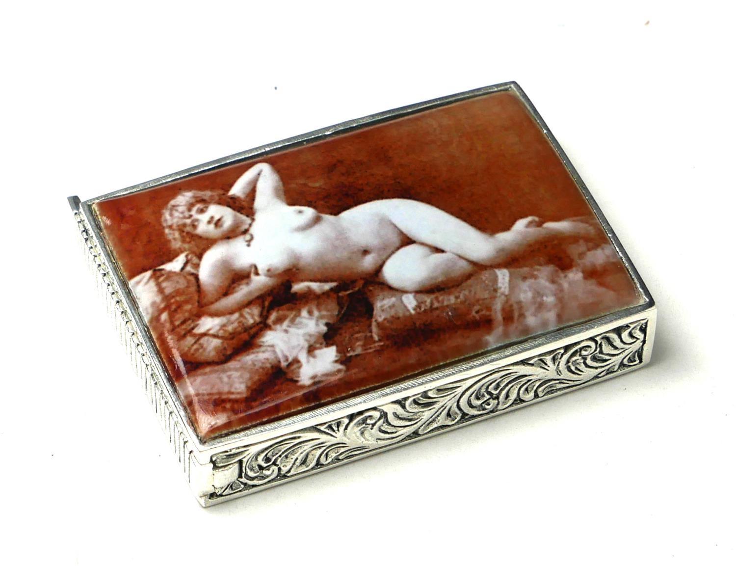 A CONTINENTAL SILVER AND ENAMEL 'EROTIC' VESTA CASE Having a photographic sepia tone reclining