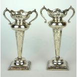 A PAIR OF EARLY 20TH CENTURY SILVER FLOWER VASES Having twin handles and pierced decoration on