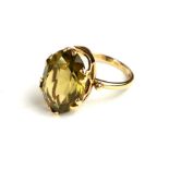 A VINTAGE 9CT GOLD AND CITRINE RING Having a single oval faceted stone on plain gold shank (size S).