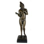 A BRONZE STATUE ROMANESQUE NAKED BOY HOLDING AN APPLE On black marble base. (51cm) Condition: good