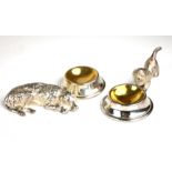 A PAIR OF NOVELTY SILVER PLATED TABLE SALTS FORMED AS DOGS WITH BOWLS.