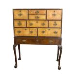 A GEORGE III RED WALNUT CABINET ON STAND The top with an arrangement of tooled leather drawers and