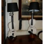 AN UNUSUAL PAIR OF VIOLIN DESIGN ELECTRIC LAMPS Two hand painted violins with black fabric shades,
