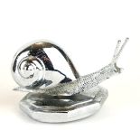 A VINTAGE CHROME CAR MASCOT FORMED AS A SNAIL. (11cm x 7.5cm) Condition: good