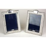 A PAIR OF ENGLISH HALLMARKED SILVER PHOTOGRAPH FRAMES. (13.5cm x 19cm)