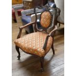 A LATE VICTORIAN MAHOGANY CHILD'S OPEN ARMCHAIR The carved frame with central oval panel in floral