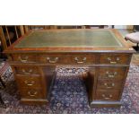 A 19TH CENTURY WALNUT AND OAK TWIN PEDESTAL DESK With green tooled leather top above an