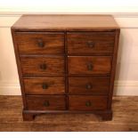 A 19TH CENTURY MAHOGANY CHEST OF EIGHT SHORT DRAWERS Fitted with brass knob handles, on bracket