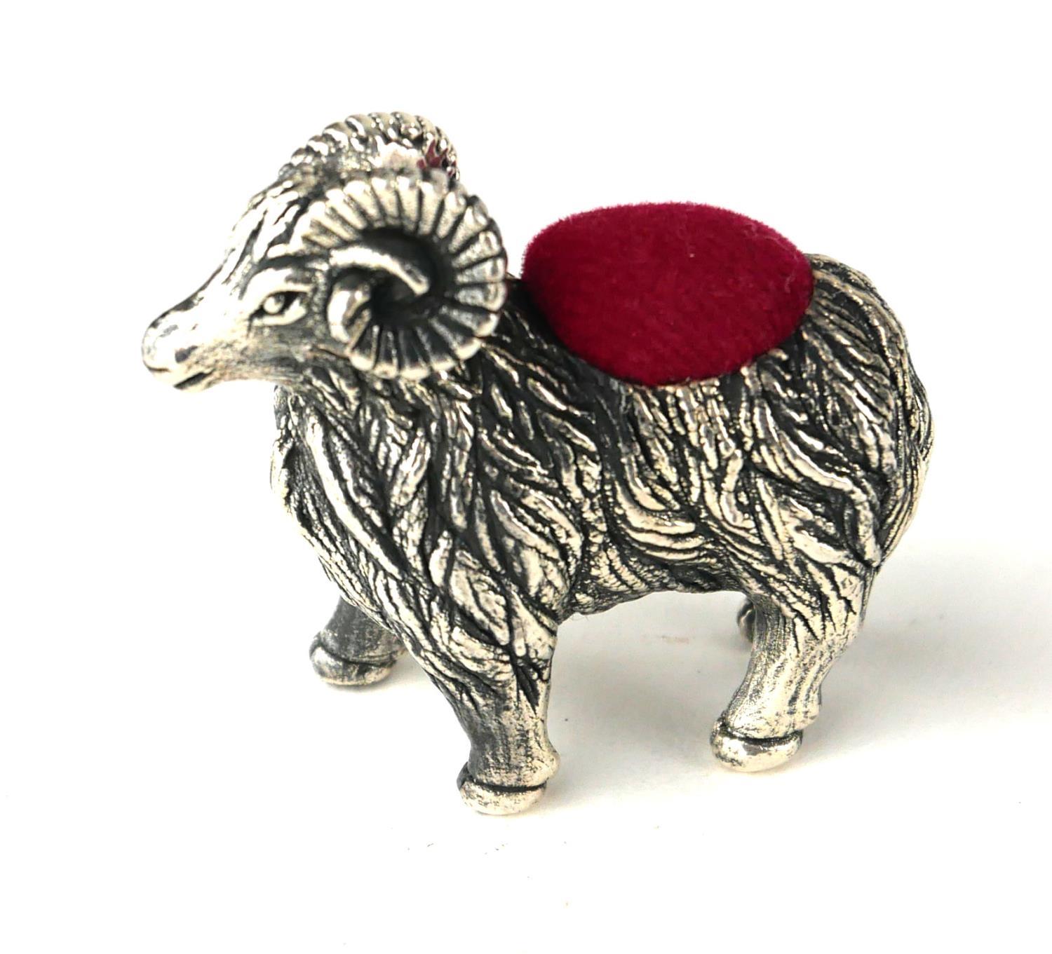 A STERLING SILVER NOVELTY 'RAM' PIN CUSHION Standing pose, with red velvet cushion. (approx 3.5cm)