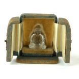 A 19TH CENTURY ROCK CRYSTAL MINIATURE STATUE OF A SEATED BUDDHA In velvet lined fitted leather case.