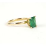 A VINTAGE 14CT GOLD AND EMERALD RING Having a single baguette cut stone (size K). (emerald Approx