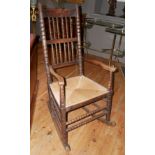 A 19TH CENTURY FRUITWOOD BOBBIN TURNED COUNTRY ROCKING CHAIR With rush seat (w 58cm x d 73cm x h
