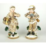 A PAIR OF 19TH CENTURY GERMAN PORCELAIN FIGURES, BOY AND GIRL Wearing period dress, gilt robes and