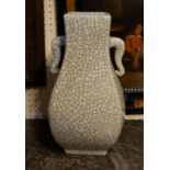 A CHINESE CELEDON CRACKLE GLAZE PORCELAIN VASE Having twin elephant mask handles and square base, in