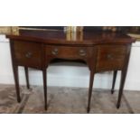 A GEORGIAN MAHOGANY BOW FRONTED SIDEBOARD With line inlays and central drawer light by cupboards,