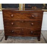 A VICTORIAN MAHOGANY BOW FRONTED CHEST OF THREE LONG DRAWERS With turned wooden handles, raised on