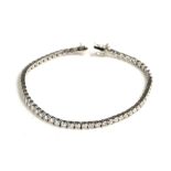 AN 18CT WHITE GOLD AND 5.22CT DIAMOND LINE BRACELET Having a row of round cut diamonds in a plain