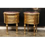 A PAIR OF FRENCH DESIGN OVAL GILTWOOD SIDE TABLES With rouge marble inset tops above three