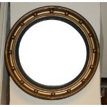 A REGENCY STYLE CONVEX MIRROR With eagle crest above circular silvered plate, along with another. (
