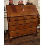 AN 18TH CENTURY MAHOGANY BUREAU The fall front enclosing a stepped fitted interior with secret