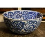 A LARGE ORIENTAL BLUE AND WHITE PORCELAIN BOWL Having an underglaze blue decoration of scrolled