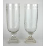 A PAIR OF CUT GLASS STORM LAMPS With herring bone decoration, on stepped square platform bases. (