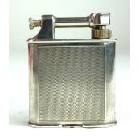 DUNHILL, AN EARLY 20TH CENTURY SILVER PLATED SQUARE LIFT ARM LIGHTER With engine turned