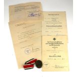 A GERMAN WWII BRONZE WOUND BADGE, 1940 Complete with paperwork.