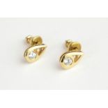 A PAIR OF 18CT GOLD AND DIAMOND STUD EARRINGS The single round cut diamond in a pierced tear form