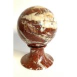 A CARVED ROUGE MARBLE SPHERE Classical form, on a socle base. (approx diameter 16cm)