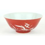 A CHINESE CORAL GROUND RESERVE DECORATED 'BAMBOO' BOWL Having a white bamboo design to body and a