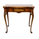 A 19TH CENTURY FIGURED WALNUT FOLD OVER TEA TABLE The shaped top over single drawer, raised on