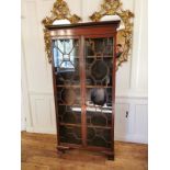 A LATE 19TH/EARLY 20TH CENTURY SOLID MAHOGANY BOOKCASE With Greek Key cornice above two astragal