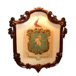 A 19TH CENTURY COAT OF ARMS PAINTED ON SILK In finely carved mahogany shield shaped frame. (56cm x