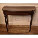 A REGENCY PERIOD MAHOGANY FOLD OVER TEA TABLE Raised on turned and fluted legs. (91cm x 45cm x 73cm)