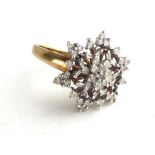 A VINTAGE YELLOW AND DIAMOND CLUSTER RING The arrangement of round cut diamonds forming a pierced