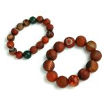 TWO ANCIENT CHINESE AGATE BEAD BRACELETS Each having a single row of spherical agate beads. (largest