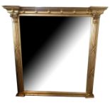 A REGENCY DESIGN GILT FRAMED MIRROR The central silver plate flanked by Corinthian columns. (153cm x