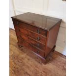 A VICTORIAN MAHOGANY CHEST Of four long graduated drawers fitted with loop handles, raised on