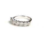 AN 18CT WHITE GOLD AND 1.82CT DIAMOND SEVEN STONE RING Having a single row of round cut diamonds