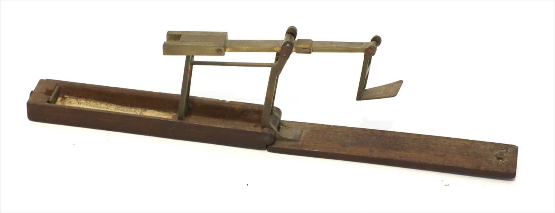 A rosewood cased brass folding coin scale,