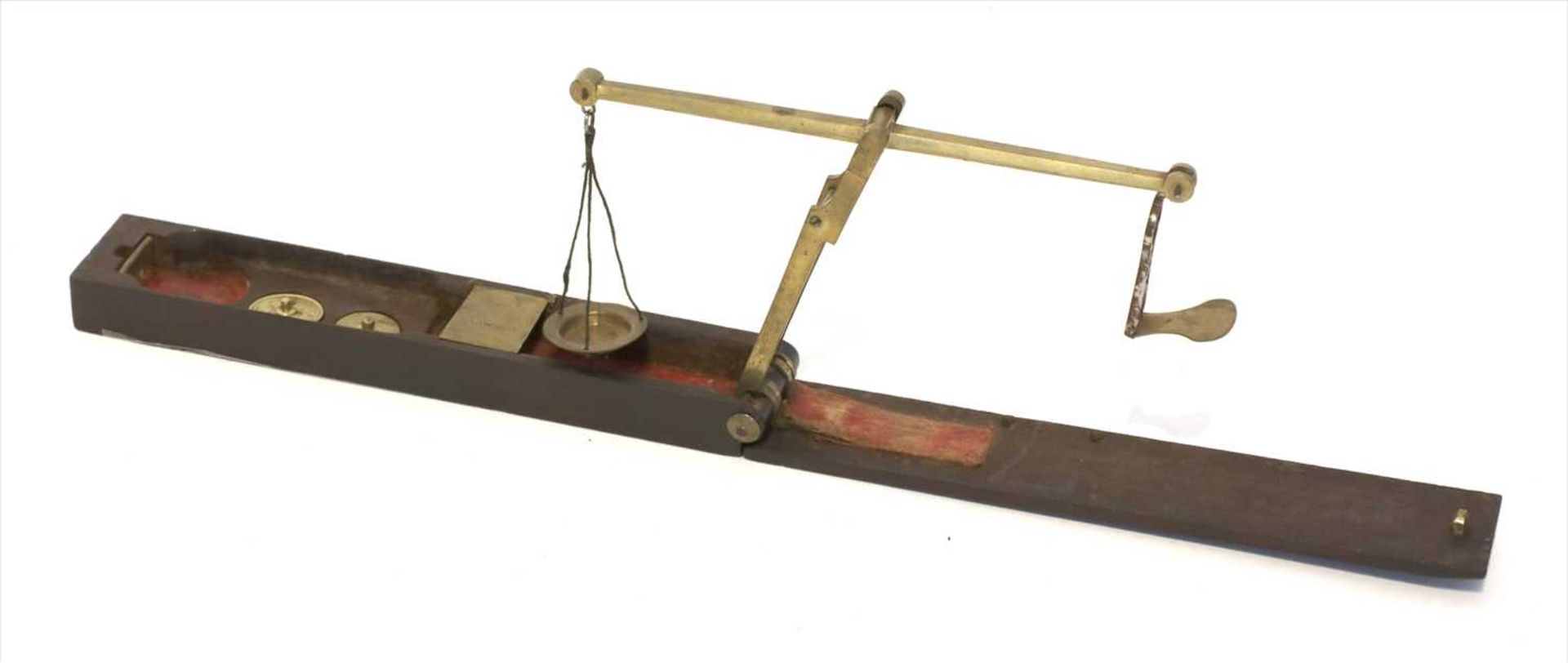 A rosewood cased brass folding coin scale,