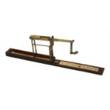 A mahogany cased folding brass coin scale,